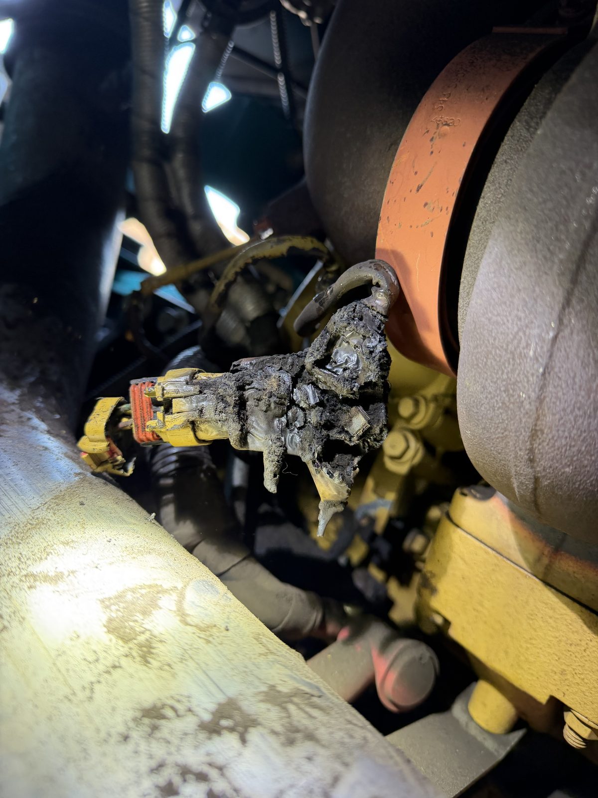 Wiring harness connector caked with oil and carbon where it runs against a turbocharger
