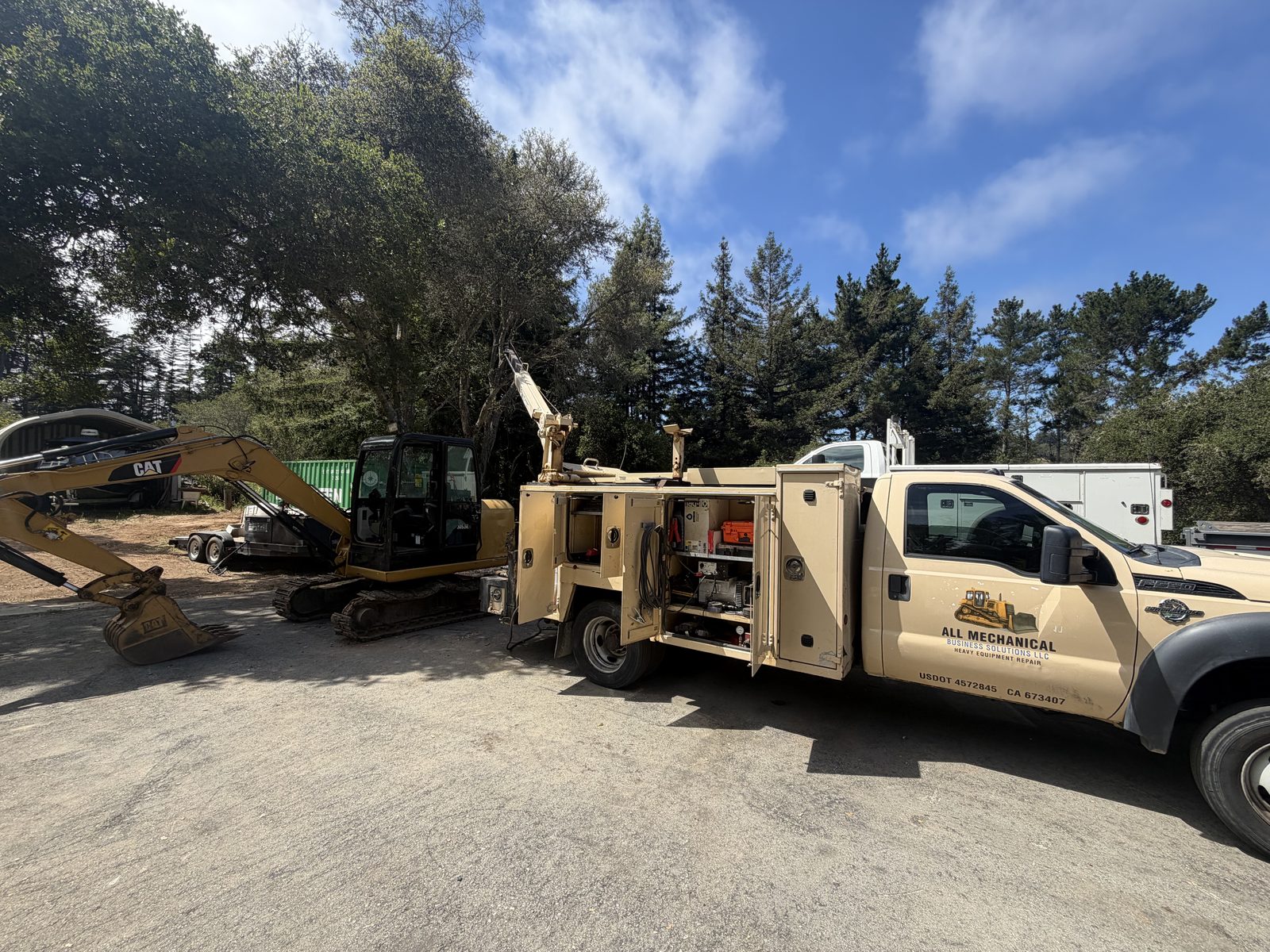 All Mechanical service truck working on a CAT excavator in the field